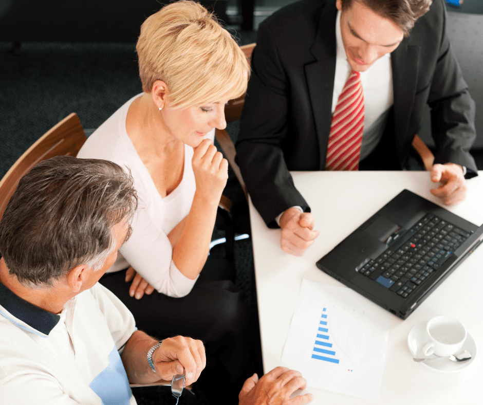 A couple is discussing with financial advisor what are the best plans for retirement | Outlook Wealth Advisors